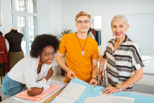 Three instructors smiling in studio